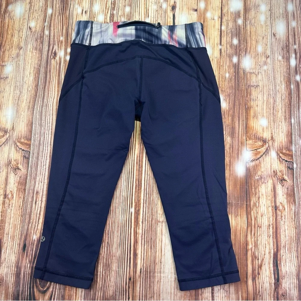 Lululemon Dark Navy ,colorful waist ban and slightly cropped leggings Size 8.